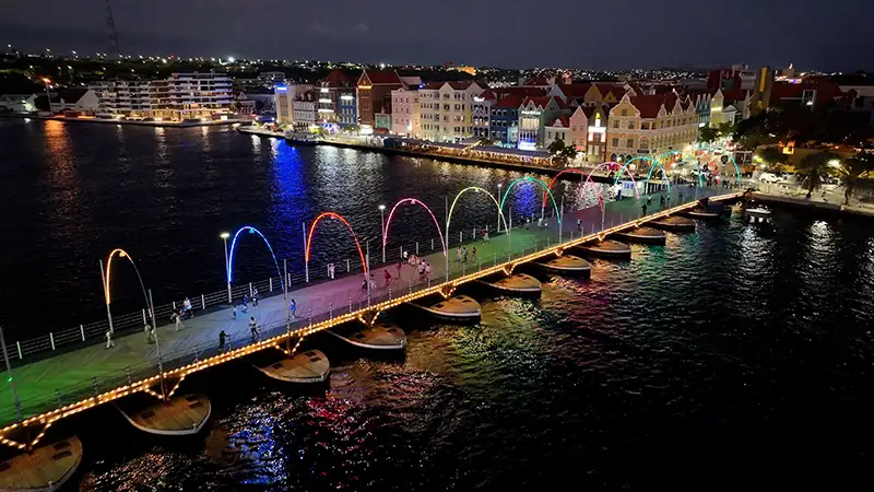 Willemstad waterfront and Queen Emma Bridge illuminated at night